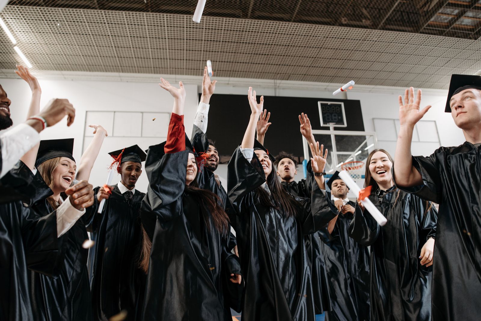 Graduates celebrating together in caps and gowns